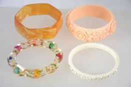 A collection of four vintage plastic bangles dating from the 1950's and 60's.