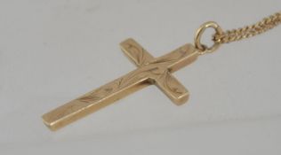 A hallmarked 9 ct gold crucifix cross pendant necklace with a foliate chase decorated crucifix