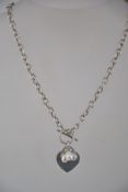 A hallmarked 925 silver necklace with heart and pearl charm with toggle clasp.
