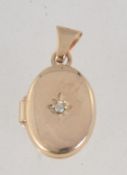 A 9ct gold and diamond locket pendant set with single diamond in a star setting approx 2pts.