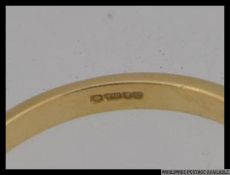 An 18ct gold 3 stone diamond ring, The round cut diamonds approx 20pnts. Hallmarked London.