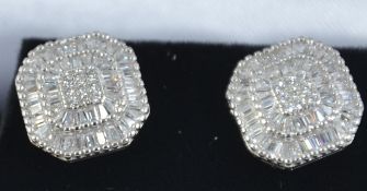 A pair of ladies contemporary silver and cz adorned stud earrings of hexagonal form.