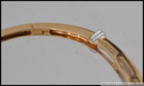 A hallmarked 18ct gold and diamond bracelet bangle with approx 150pts of cushion cut diamonds in a