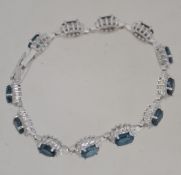A ladies contemporary silver and London blue topaz bracelet,