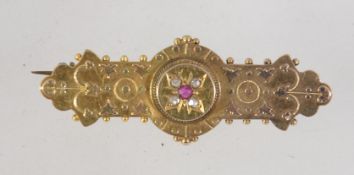 A Victorian 15ct gold ruby and diamond brooch pin with granulated and filigree decoration set with