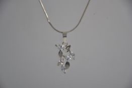 A 925 silver pendant necklace with modernist foliate pendant set with marquise clear gem stones.