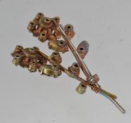 A vintage white metal flower spray brooch set with clear and blue round and baguette rhinestones