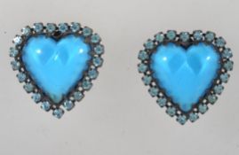 A pair of large vintage heart clip on earrings with central blue cabochon with blue rhinestone halo.
