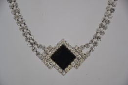 A vintage 1980s white rhinestone necklace with large central french Jet stone with in a silver tone