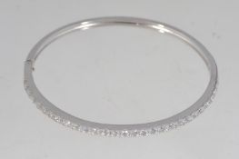 A 925 silver channel set CZ bangle with safety clip clasp.