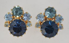 A pair of vintage rhinestone set yellow metal clip on earrings set with blue tone rhinestones.