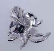 A vintage white metal paste set brooch in the form of a trumpeting daffodil with roller clip clasp.