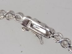 A 925 silver channel set CZ line bracelet with safety clip clasp. Measures 7.5 inches.