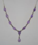 A sterling silver and amethyst necklace with pear shaped cabochons and bolt ring clasp. Marked 925.