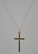 A hallmarked 14ct gold pendant necklace strung with a 9ct diamond cut decorated crucifix on gold