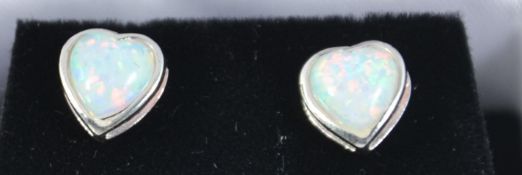 A pair of silver and heart shaped ladies opal earrings - studs complete in the presentation box.