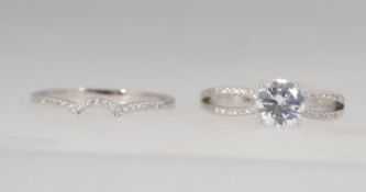 A designer 925 silver stacking ring set with a central clear stone with split shoulders with