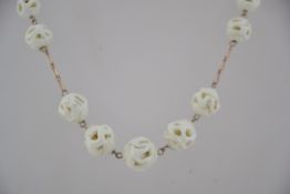 A vintage Czech rolled gold wire work glass lampwork lattice bead necklace with hook clasp.