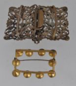 A white metal Czech buckle belt clip set with turquoise and clear paste stones in a foliate pierced