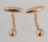 A pair of 15ct gold cufflinks with torpedo and ball linked by chain . Marked SS 15. Tests 15ct gold.