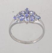 A hallmarked 9ct white gold tanzanite and diamond cluster ring. Hallmarked for Sheffield. Size T.