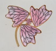 A vintage yellow metal modernist brooch with foliates and central pik rhinestone with roller clip