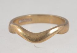 A hallmarked 9ct gold ring with plain whishbone decoration. Size I.5. Weight 1.9g.