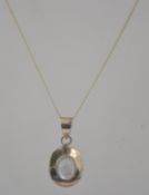 A 925 silver pendant necklace with moon stone cabochon pendant in a rub over setting. Marked 925.