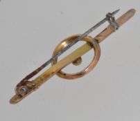 A vintage 9ct gold yellow metal bar brooch with central overlapping ring.