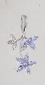 A hallmarked 9ct white gold tanzanite and diamond drop pendant set with diamonds and tanzanite in a