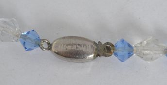 A vintage Czech glass bead necklace with faceted clear and blue glass beads with a paste set clip