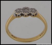 An 18ct gold and platinum diamond ring set with a central diamond with illusion platinum stones