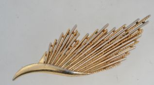 A huge vintage gold tone Crown Trifari brooch in the form of a stylized wing.