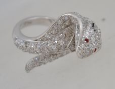 A fabulous silver and cz adorned snake charmer / snake ring with ruby garnet stone eyes.