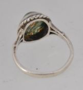A 925 silver dress ring with central moss agate cabochon surrounded by a rope twist setting.