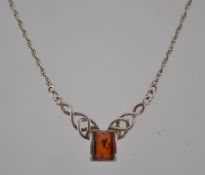 A sterling silver and amber celtic style necklace with lobster claw clasp,. Marked 925.