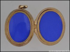 A hallmarked 9ct gold locket with flower decoration to front set with a cluster of garnets.