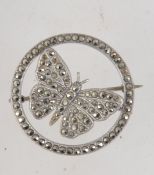 A vintage 925 silver and marcasite brooch pin in the form a butterfly within a roundel with C clip