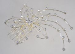 A large vintage white metal hair comb with star burst rhinestone decoration. Measure 10cms.