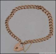 A 9ct gold belcher chain bracelet with heart shaped lock and safety chain.