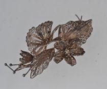 A large vintage white metal tests silver filigree floral spray brooch. Measures 6.5cms.