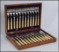An Edwardian oak cased 12 piece fish cut