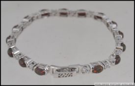 A silver and CZ and Tourmaline bracelet.