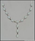 A fine silver CZ and opal necklace