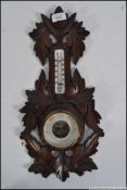 A carved Black Forest aneroid barometer