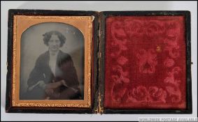 A 19th century Ambrotype photograph of a seated lady with hand written notation to the inside of