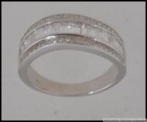 A silver and CZ half eternity ring