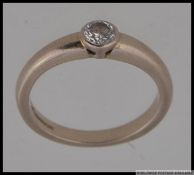 An 18ct / 750 white gold and diamond sin