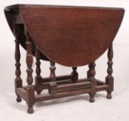 A 1920's oak drop leaf dining table rais