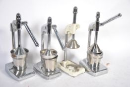 A group of 3 retro chrome juicers / extractors along with another vintage juicer